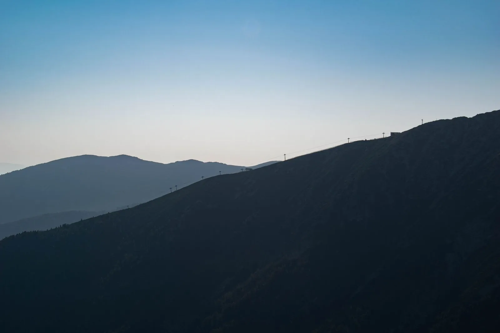 Mountain silhouette at dusk near Bansko, Bulgaria. Photo by Luka Peric.