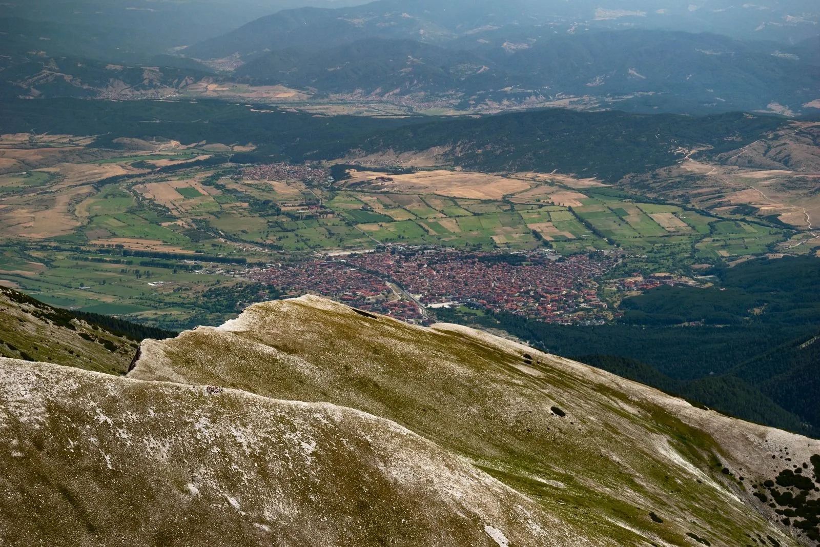 Aerial view of Bansko town below the hills, Bulgaria. Photo by Luka Peric.