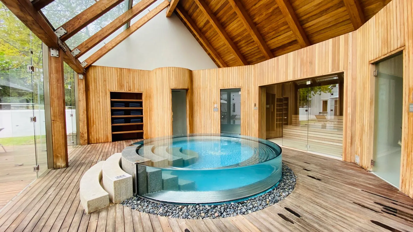 Modern indoor spa with wooden interior and a round jacuzzi. Photo by Jill A. Patience.